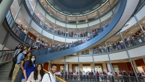 Students standing on spiral staircase