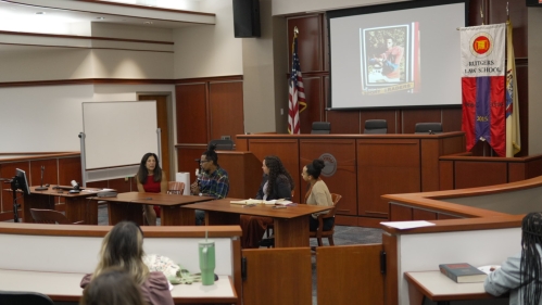 Group seated at table in mock courtroom