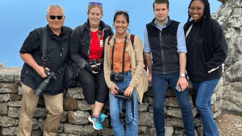 Students with cameras smiling on table mountain in South Africa