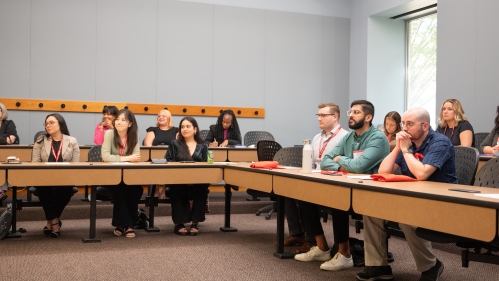 Two groups of seated students participate in a lecture during an orientation at Rutgers Law School.