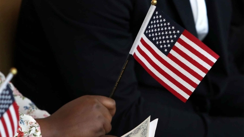 Hand holding small American flag