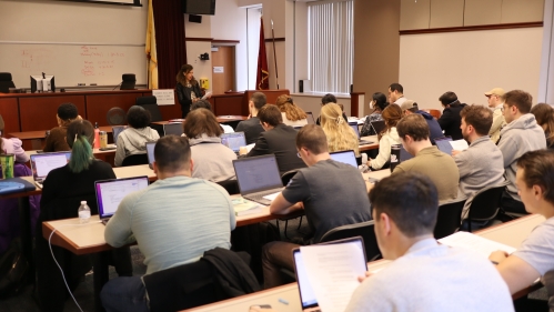 professor teaching in front of large class