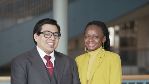 man and woman standing next to each other and smiling