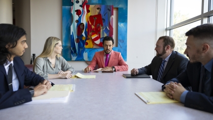 Men and woman sitting around conference table