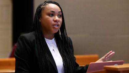 woman in black suit in mock courtroom