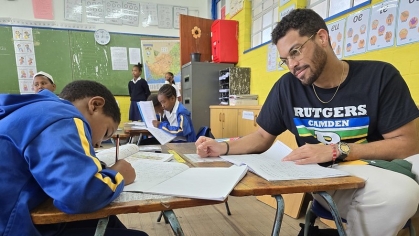 Man in South Africa classroom with student