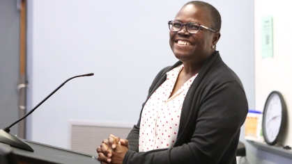 Teacher at podium smiling