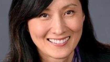 woman in a suit posing for a photograph