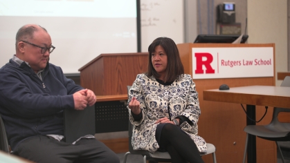 man and woman sitting in front of class and talking