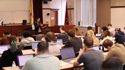 Professor Amy Widman teaching in front of large class 
