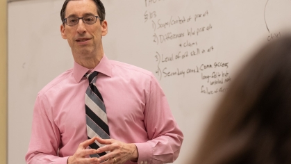 Professor at whiteboard teaching class