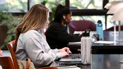 Two female students studying at laptops