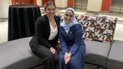 Two women seated and smiling