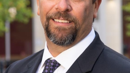 man in a suit posing for a photograph