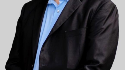 man in a suit posing for a photograph