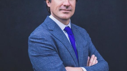 man in a suit posing for a photograph