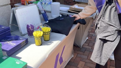 woman grabbing an item from a table