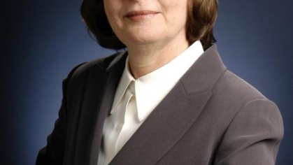 woman in a suit posing for a photograph