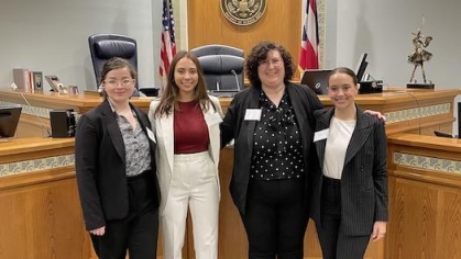 group of women in suits posing for a photograph