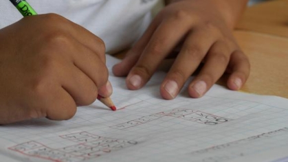 person writing something on a piece of paper