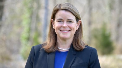 woman in a suit posing for a photograph
