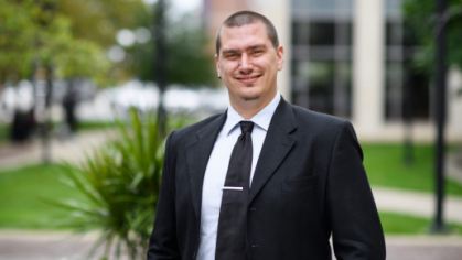 man in a suit posing for a photograph