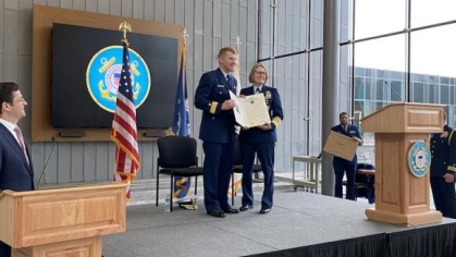 man receiving an award on a stage