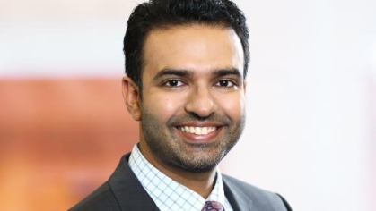 Man in a suit posing for a photograph