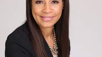 woman in a suit posing for a photograph