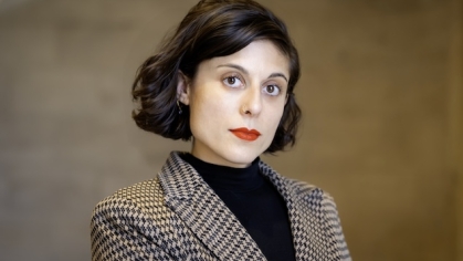 woman in blazer looking ahead