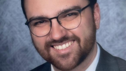 man in a suit posing for a photograph