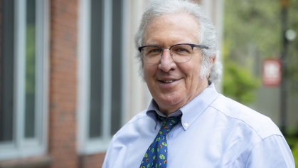 man in glasses, shirt and tie smiling