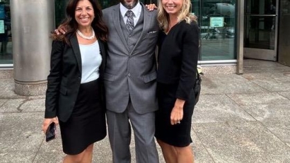 Group of people in suits posing for a photograph