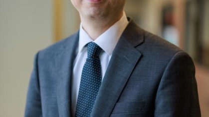 man in a suit posing for a photograph