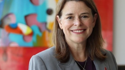 Woman in a suit posing for a photograph