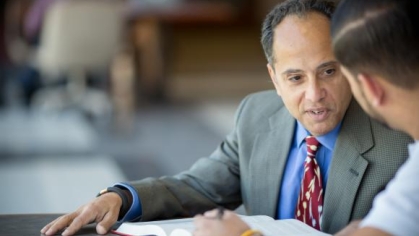 man in a suit talking to another person