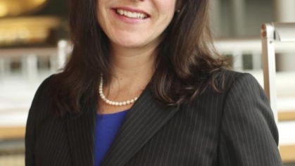 woman in a suit posing for a photograph