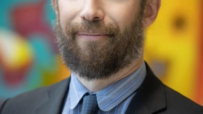 man in a suit posing for a photograph