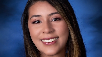 woman smiling in front of blue background