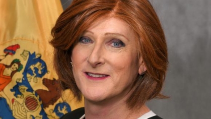 woman in a suit posing for a photograph