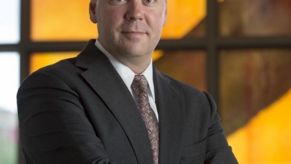 man in a suit posing for a photograph