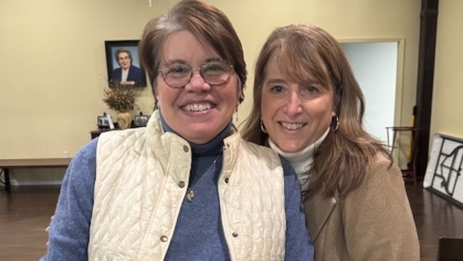 two women smiling next to each other
