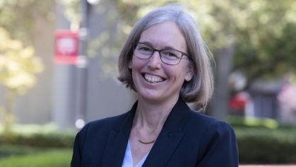 woman outside wearing glasses and smiling