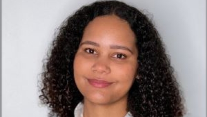 woman with curly hair grinning 