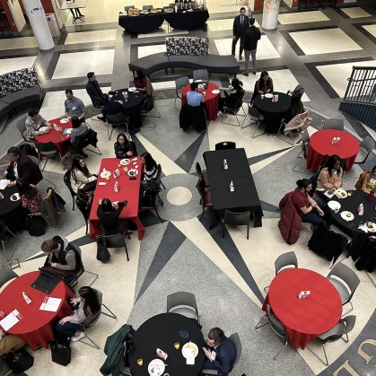Wide overhead look at admitted students having lunch in lower level atrium