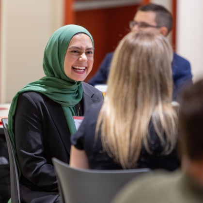 Woman in hijab sitting and smiling
