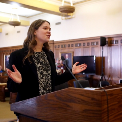 Person speaking at microphone