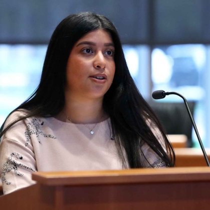 Woman speaking at microphone at podium