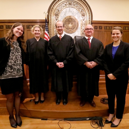 group of men and women in robes and in business attire