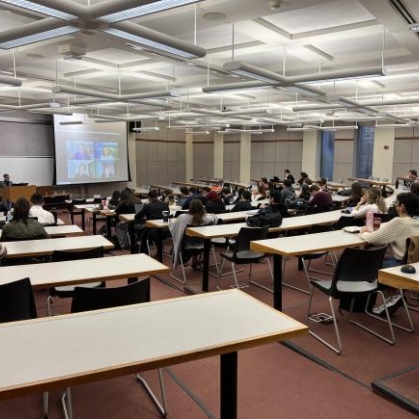 photograph of a classroom with students and a lecturer